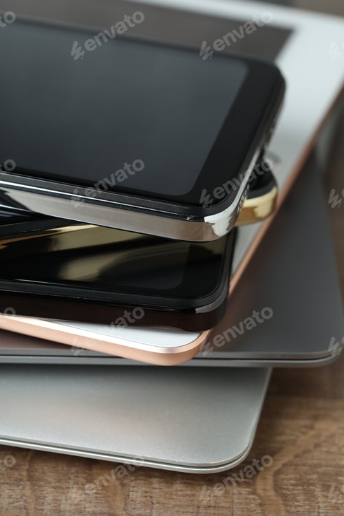 Preview: Stack of electronic devices on wooden table, closeup