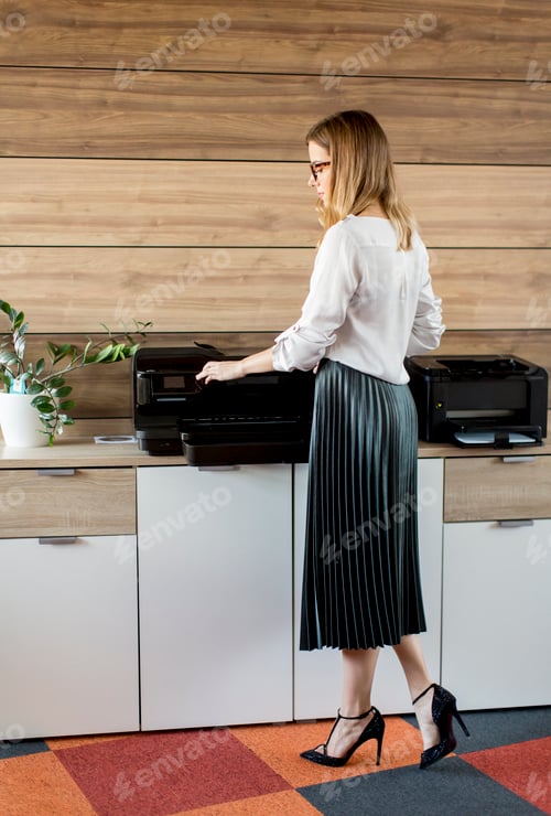 Preview: Business woman working in office by the printer