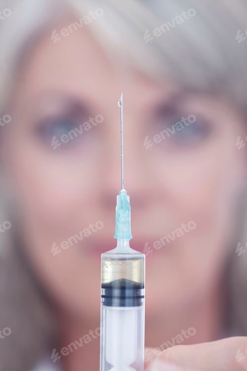 Preview: Scientist squeezing drop out of syringe