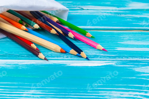 Preview: Colorful pencils on a bright blue wooden background