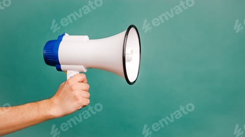 Preview: Young male hand holding a white megaphone