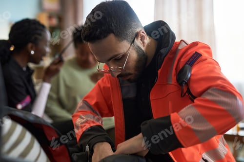Preview: Young Male Medical Professional Providing Emergency Assistance Indoors