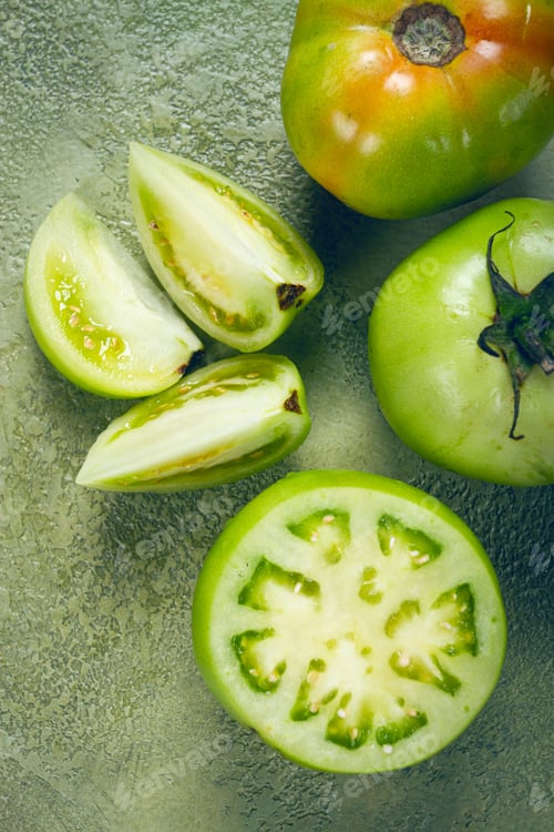 Preview: green tomatoes, sliced on the table, unripe tomatoes, raw , selective focus, no people,
