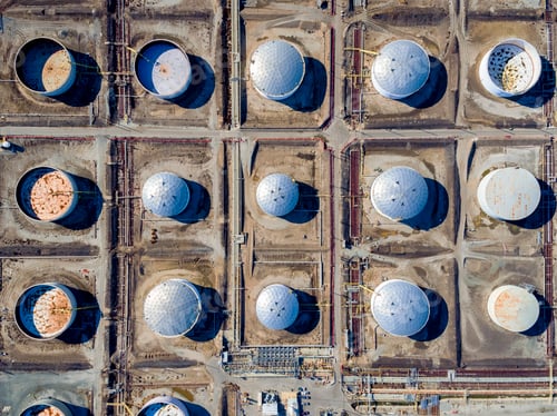 Preview: Aerial view of oil storage tanks in a grid pattern at Torrance. Round containers, covered and
