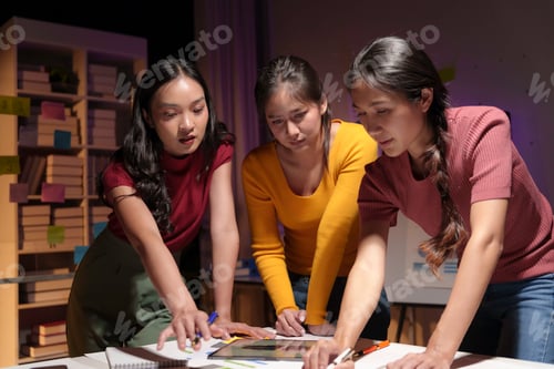 Preview: Three asian businesswomen are working late in the office