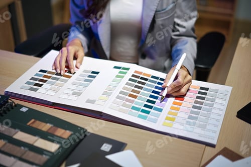 Preview: interior designer working on new house project in office. choosing materials and colors from samples