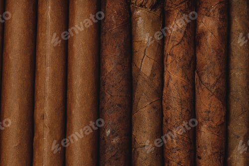 Preview: Background of stacked rolled cigars close up
