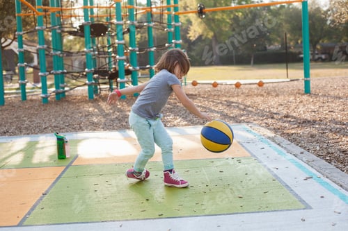 Preview: Girl bouncing basketball in playground