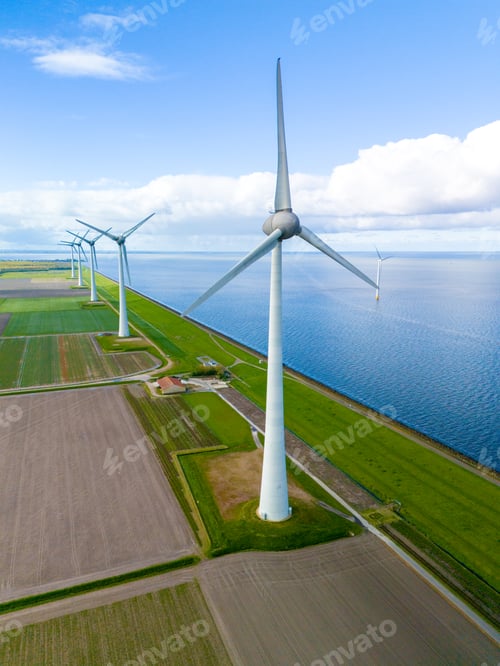 Preview: A wind farm comprised of towering turbines stands gracefully in the middle of a vast body of water