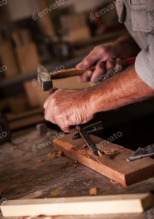 Preview: Experienced senior carpenter working in his vintage workshop.
