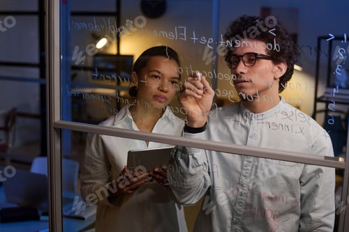 Preview: Colleagues Collaborate on Business Strategy After Hours