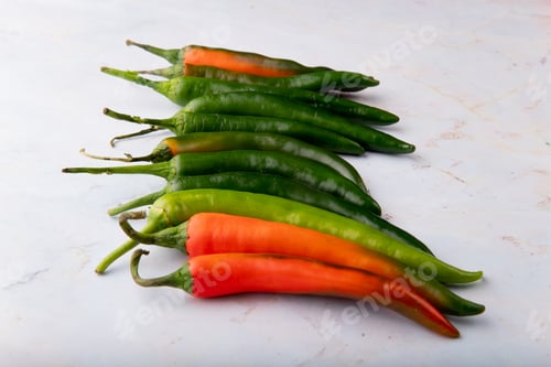 Preview: side view of peppers on white background with copy space