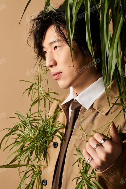 Preview: Spring fashion portrait featuring an Asian man in a stylish outfit set in a studio