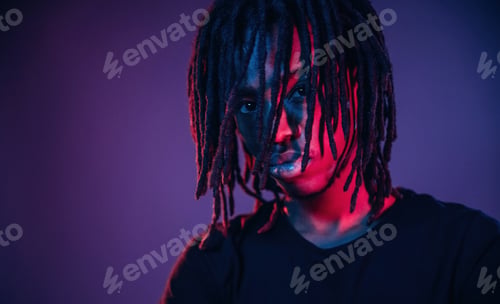 Preview: African American guy is studio with neon lighting
