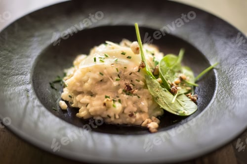 Preview: Risotto with gem fit and levisticum celery on a wood table composition