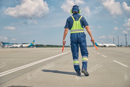 Preview: Signalman with wands going along the runway