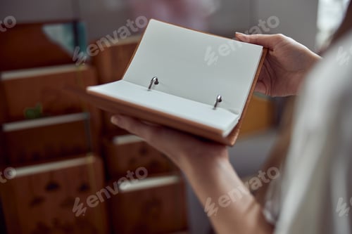 Preview: young caucasian happy lady with book at the shop