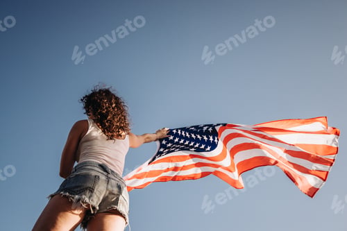 Preview: Girl with an American flag. Independence Day concept