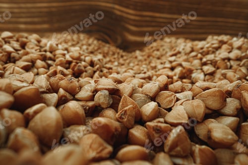 Preview: Macro photo of handful dry buckwheat grain