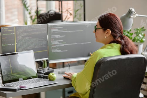 Preview: Woman Writing Script on Multiple Computer Screens