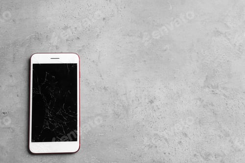 Preview: Modern smartphone with broken display and space for text on table, top view. Device repair