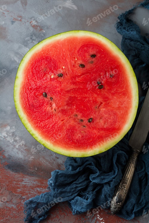 Preview: Fresh raw watermelon cut into pieces on gray stone background. Selective focus. Top view. Copy space