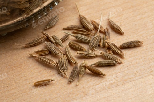 Preview: Dried cumin seeds on wooden background close up