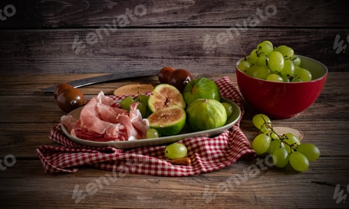 Preview: Figs, Grapes, and Ham Platter on Wooden Table