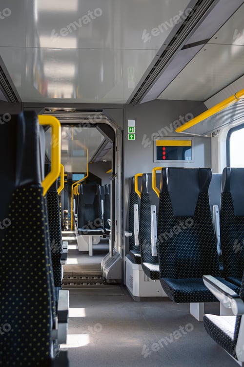 Preview: Empty train interior showing seats and walkway during a quiet travel time
