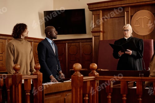 Preview: Confident female judge in black mantle passing judgement in courtroom