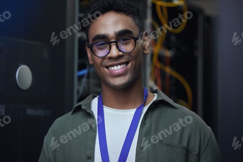 Preview: Cropped portrait of a handsome male IT support agent working in a dark network server room