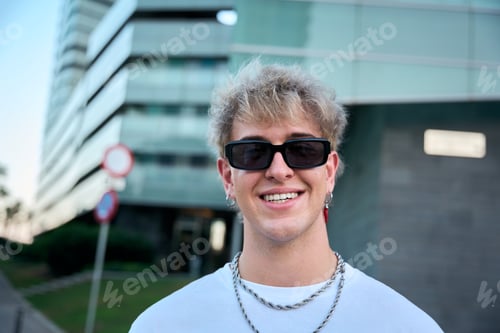 Preview: Blond gen z influencer smiling wearing sunglasses and silver chains