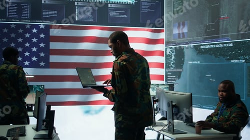 Preview: Professionals in US military uniforms operate computers and big screen