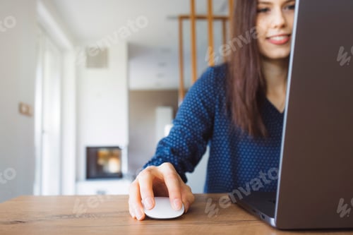 Preview: Caucasian woman sitting by the desk online shopping on her laptop