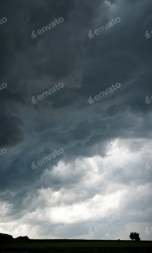 Preview: Dramatic dark cloudy sky over the field