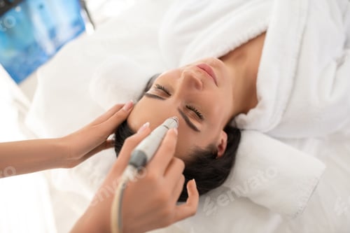 Preview: Dark-haired woman laying on the couch feeling relaxed during beauty procedure