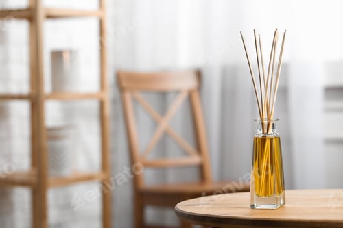 Preview: Reed air freshener on wooden table indoors, space for text