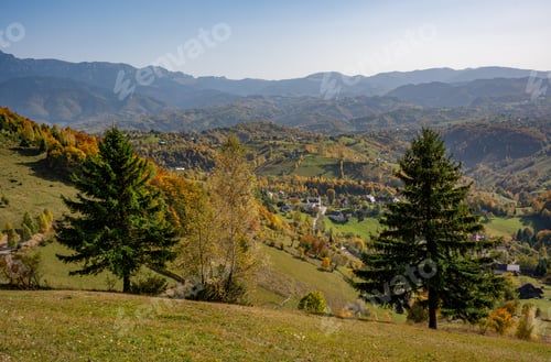 Preview: Stunning landscape of a lush mountainous region with an abundance of trees and majestic peaks