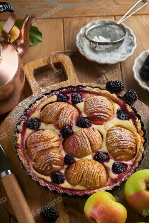 Preview: Apple pie. Apple and blackberries cake or pie decorated sugar powder on old wooden table. Delicious