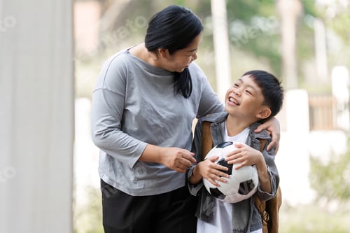 Preview: Family and Sports. A mother and son share a joyful moment as they prepare for soccer.