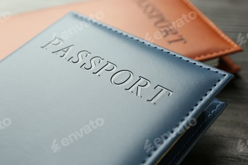 Preview: Passports in color covers on table, closeup