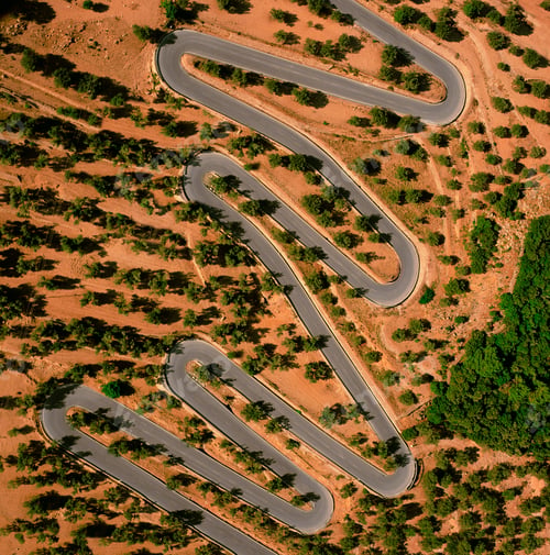 Preview: Winding road snaking through a sunkissed landscape