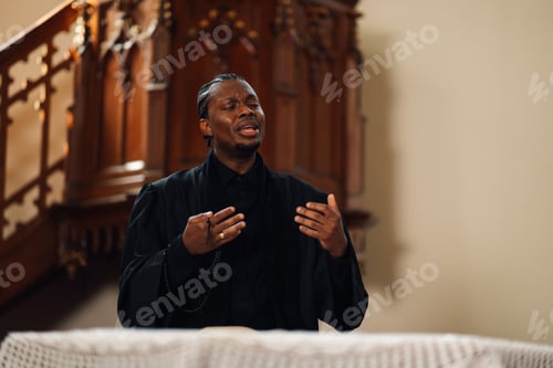 Preview: Young priest giving sermon from church altar