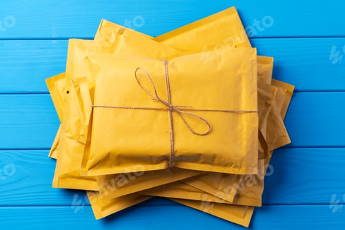 Preview: Lot of yellow paper postal envelopes. Top view.