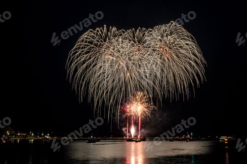 Preview: fireworks exploding into the night sky above a body of water