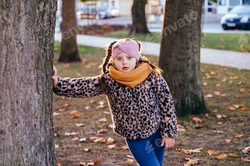 Preview: Child Leaning Against Tree Trunk in the Park