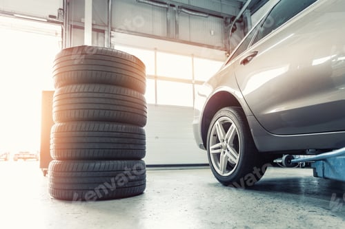 Preview: Car wheel repair with two auto lift back view. Seasonal winter tyre change at workshop. Vehicle tire