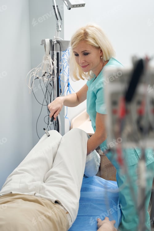 Preview: Cheerful neurologist treating male patient on couch