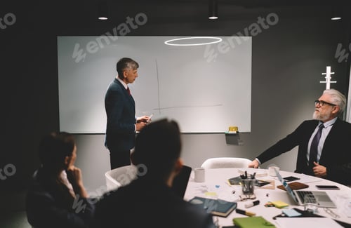 Preview: Serious businessman sharing ideas with colleagues