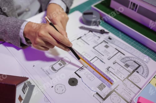 Preview: a beautiful female architect is working in her private office